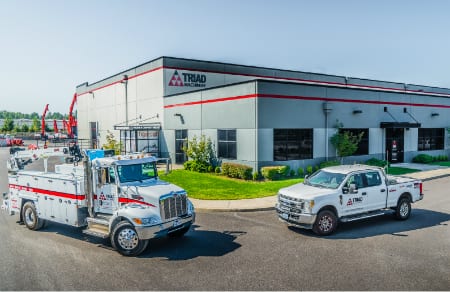 External view of Portland Triad Machinery Branch with two trucks out front to illustrate Portland Heavy Construction Equipment